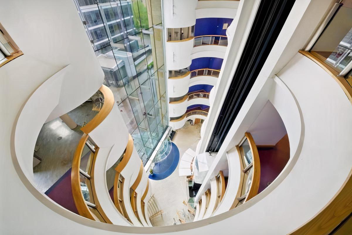 A meeting centre with curved balconies overlooking a glass atrium and modern interior at Landmark: Bristol.