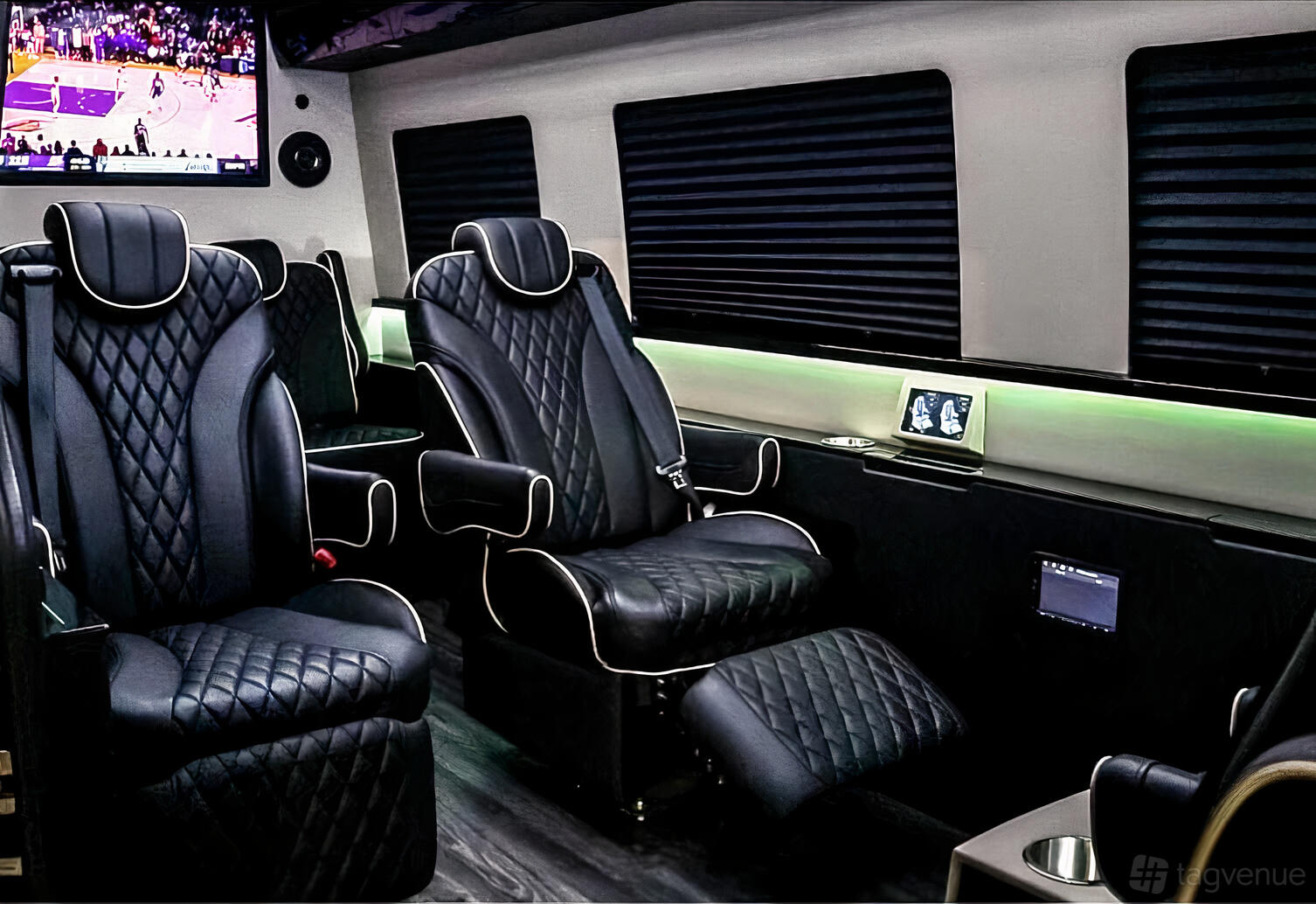A party bus with black leather captain's chairs, footrests, tinted windows, and ambient lighting at Platinum Rides.