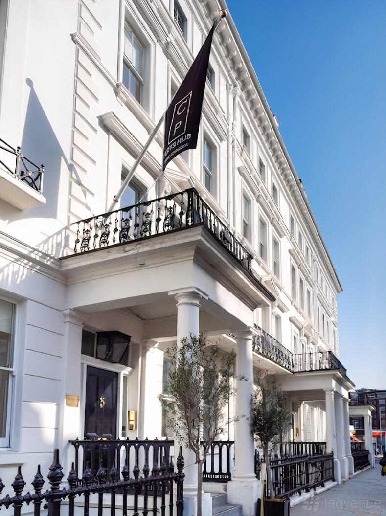 A restaurant with a white facade, wrought iron balconies, and tall columns at The Lavery.