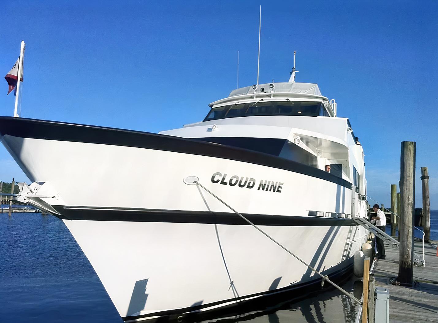 A white yacht docked at a pier with a boarding ramp at Lots Of Yachts/Lots Of Spots - New York.