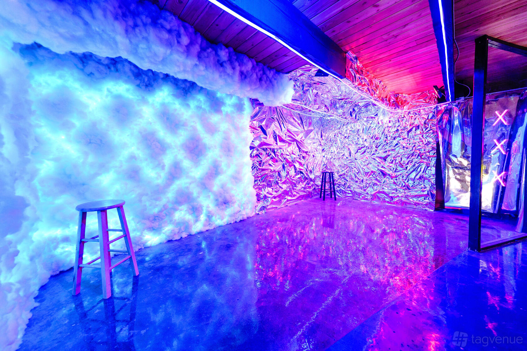 A photo studio with neon lighting, metallic walls, cloud-like textures, and reflective flooring at Chicago Studios.