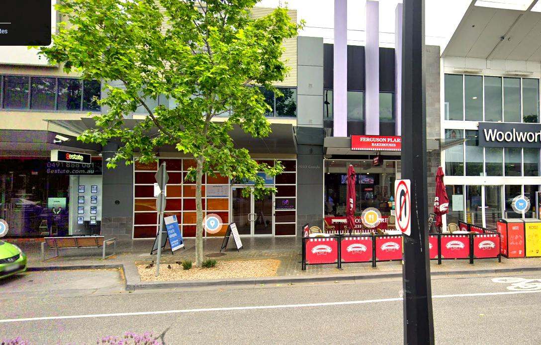 A versatile event space with a bold red glass façade and street-level entrance at Music Valley.