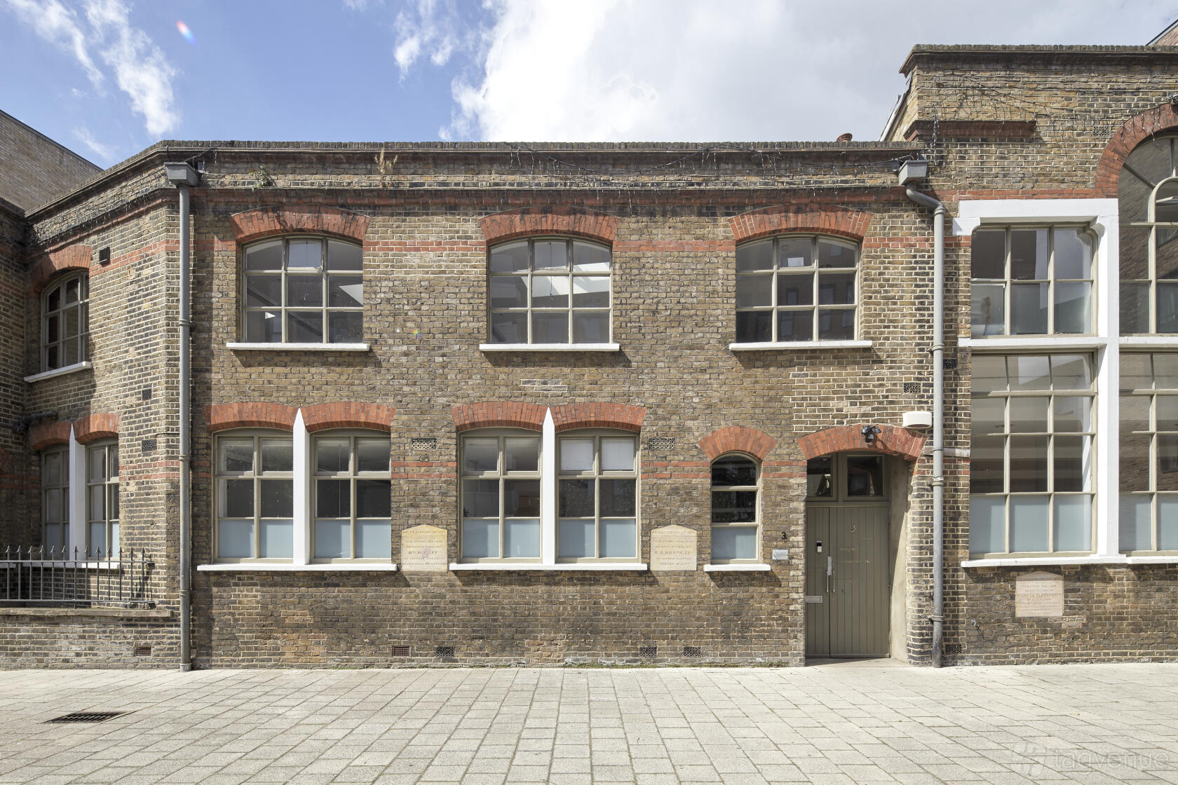 A blank canvas venue with arched windows and exposed brick exterior at Shoreditch Tab Centre.