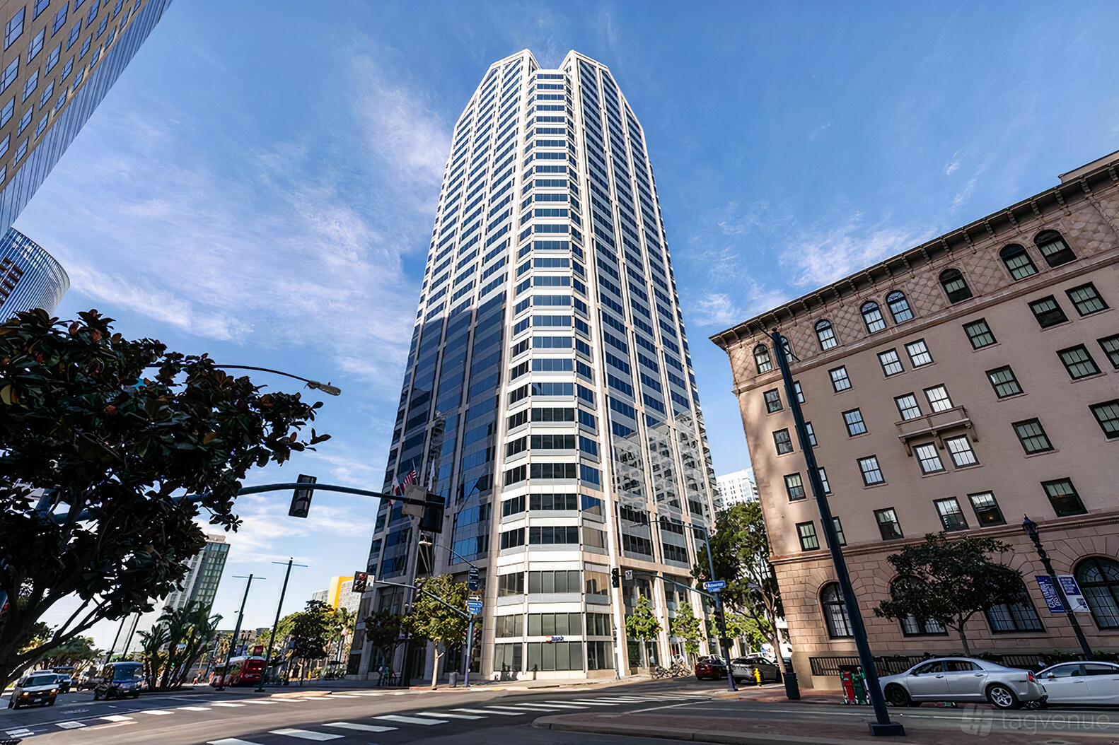 A tall glass office building with geometric architecture at Premier Workspaces - One America Plaza.