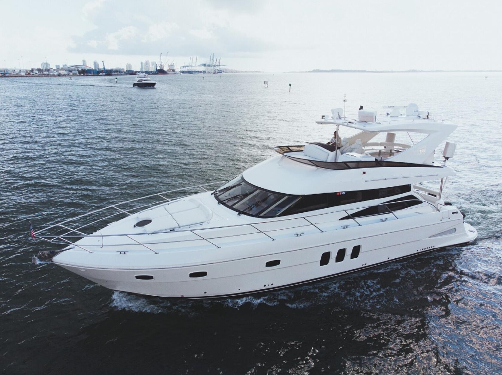 A luxury yacht with a spacious upper deck cruising on open water at The Nightfall Group.
