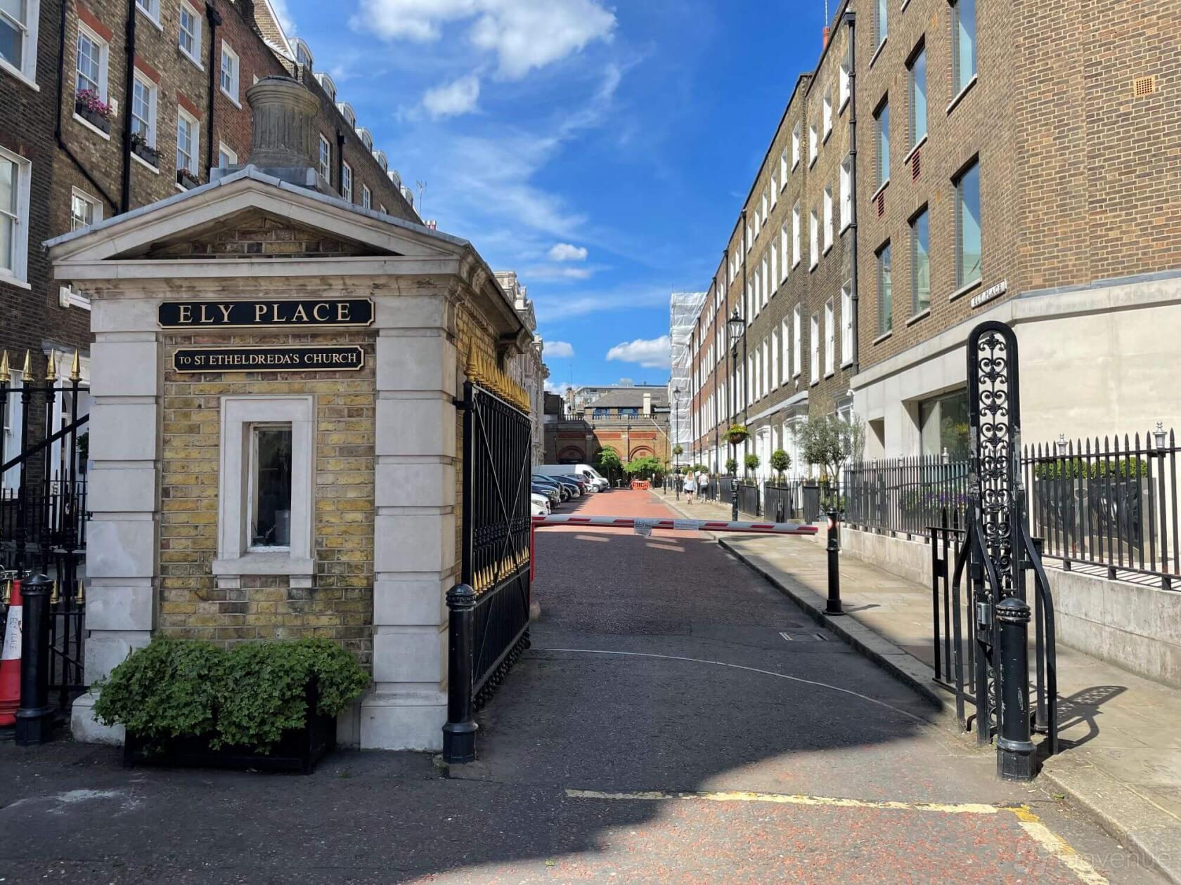 An entrance gate with brick and wrought iron details leading to Ely Place near FMB Meeting Rooms.