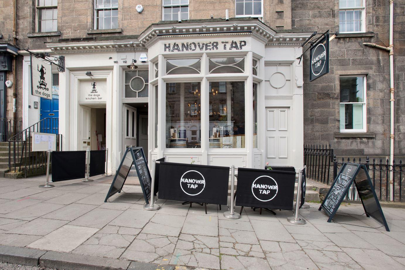 A versatile event space with a classic storefront, large bay window, and branded signage at Hanover Tap, Edinburgh.