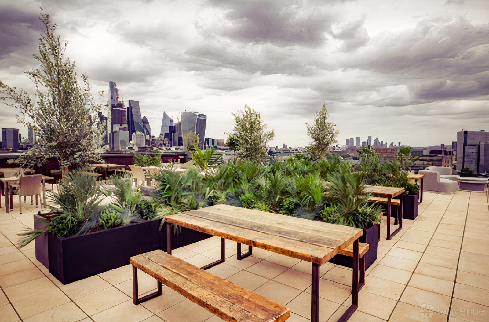 A rooftop terrace with wooden picnic tables, benches, and planters filled with greenery at Rose Court Events.