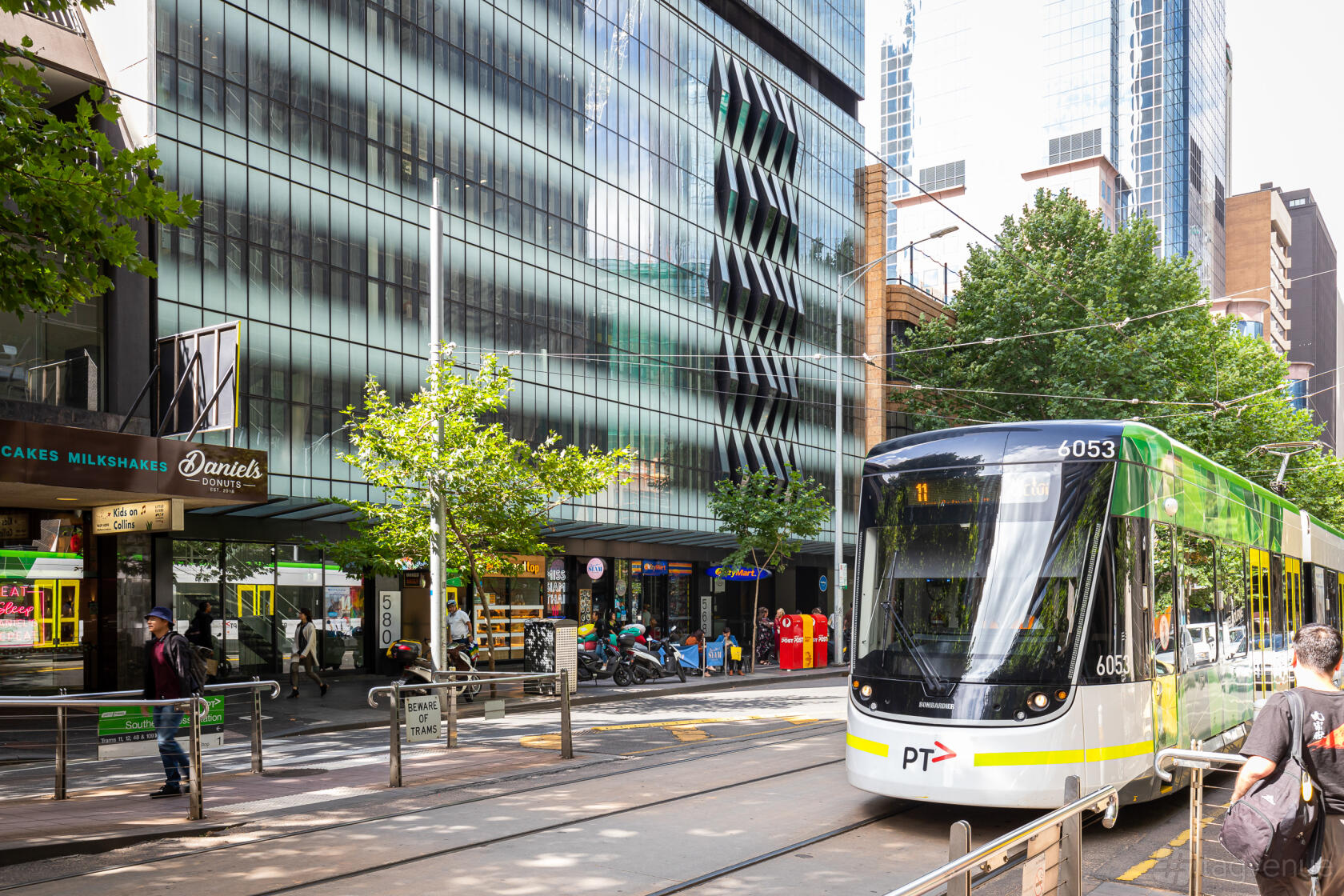 A meeting centre with a glass façade and street-level tram stop at 11th Space.