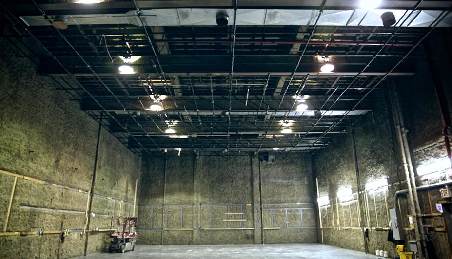 A large sound stage with high ceilings, exposed lighting grid, and textured walls at Sound Stage 1.