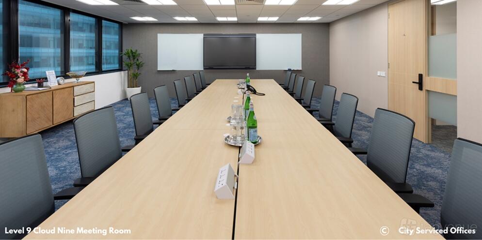 A meeting room with a long conference table, ergonomic chairs, and a wall-mounted display at Republic Plaza Tower 1 Level 9.