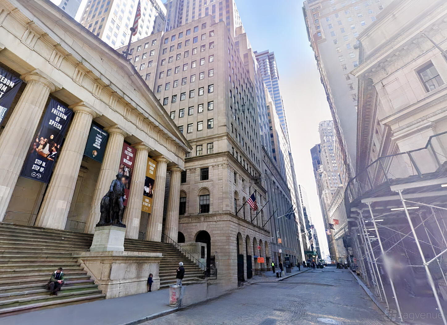 A versatile event space set in a historic building-lined street with columns and statues at Wall Street Event Space.