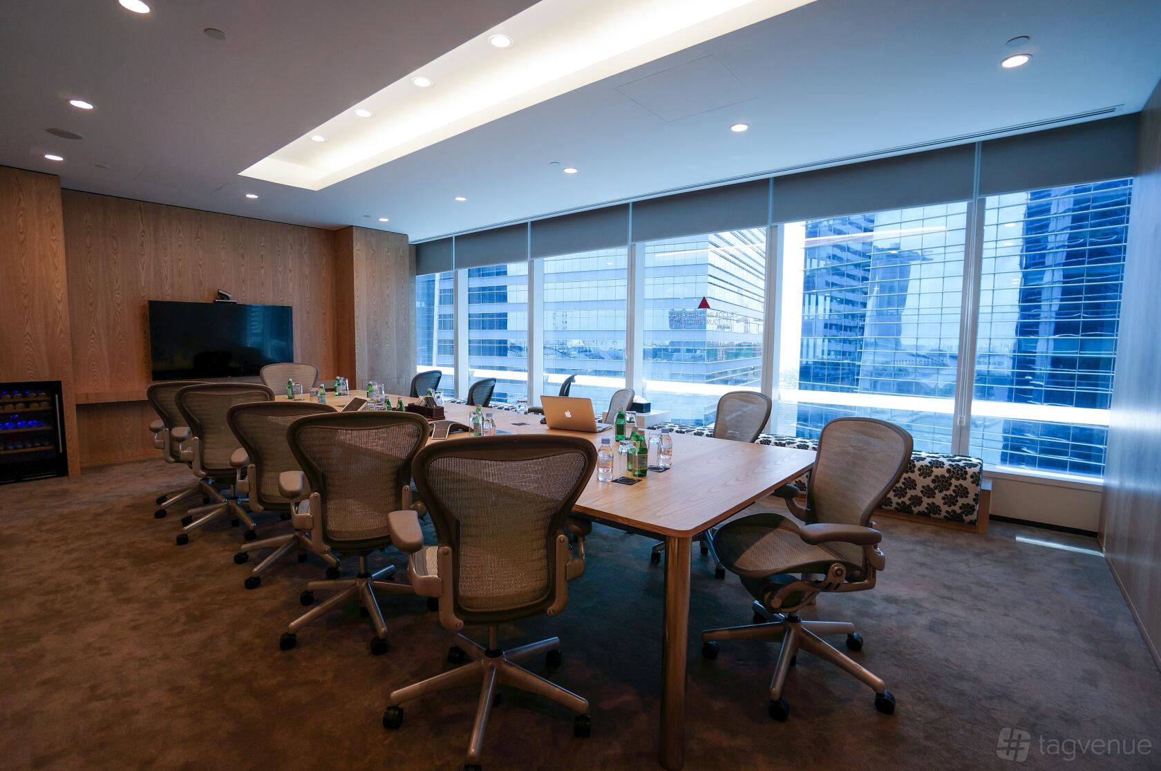 A meeting centre with a long conference table, ergonomic chairs, floor-to-ceiling windows, and city views at Marina Bay Financial Centre Tower 1.