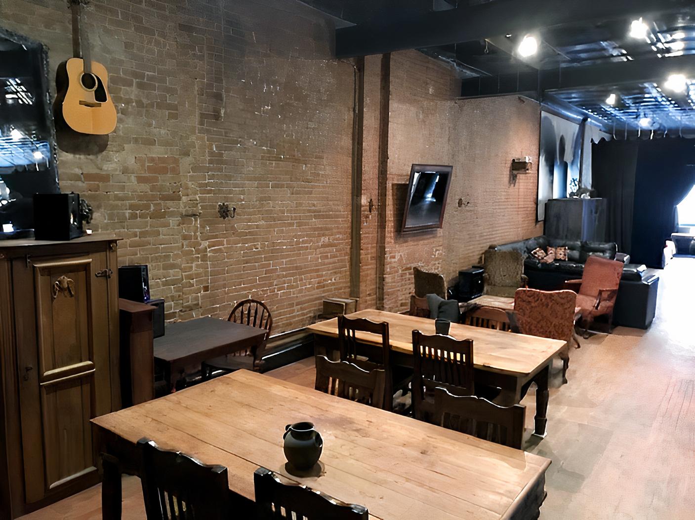 An event venue with exposed brick walls, wooden tables, and mixed vintage seating at Inspace.