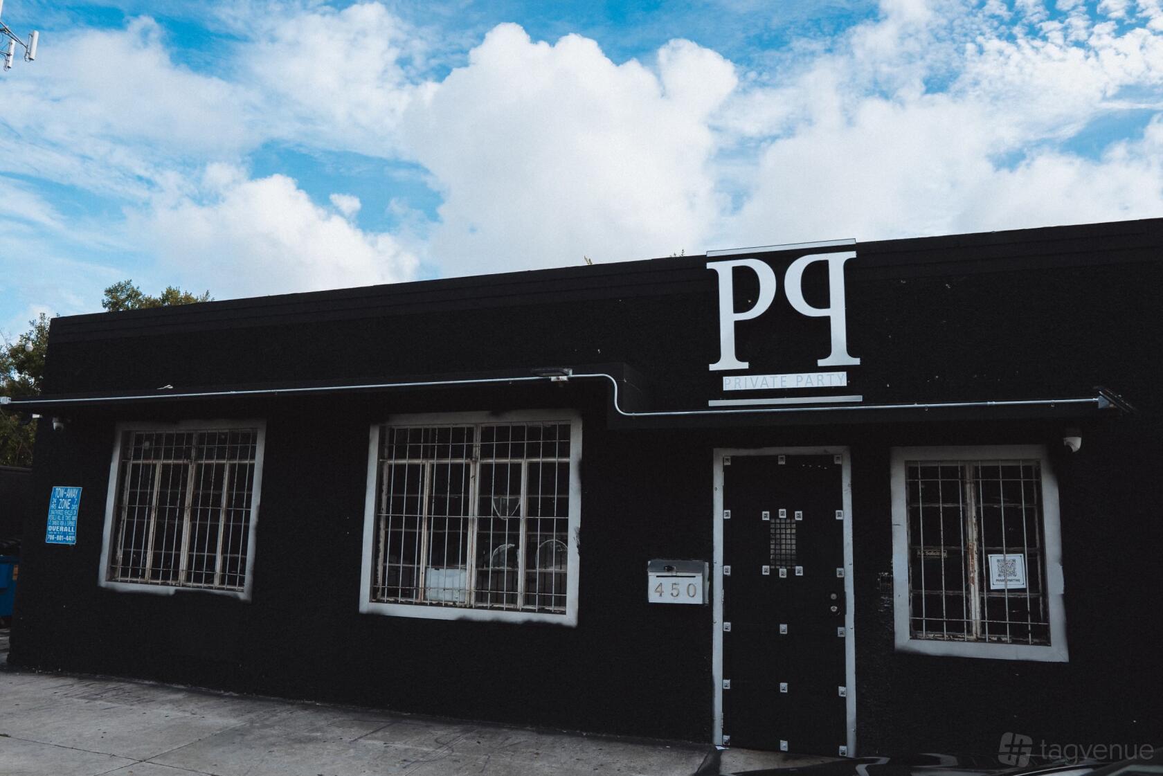 A versatile event space with a black facade, metal-barred windows, and bold white signage at Private Party.