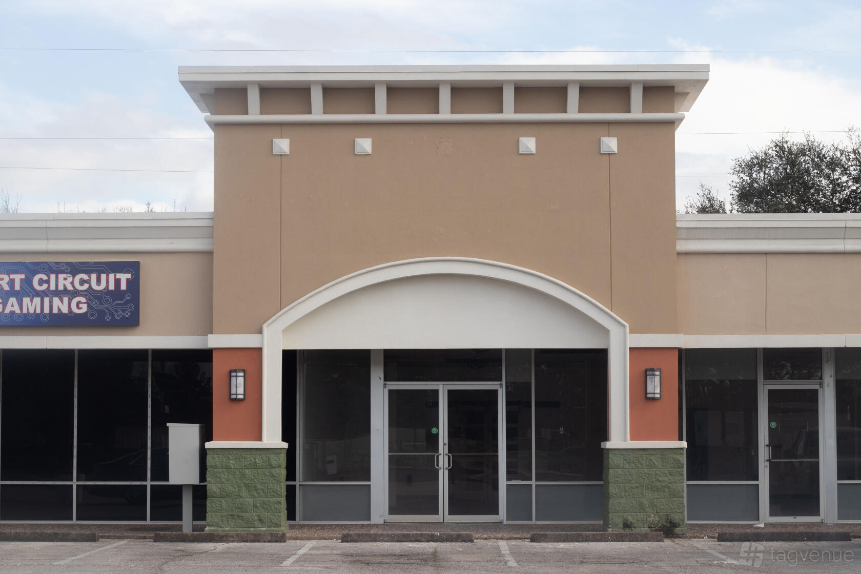 An event space with a neutral facade, large front windows, and double glass doors at Terra Belle Event Studio.