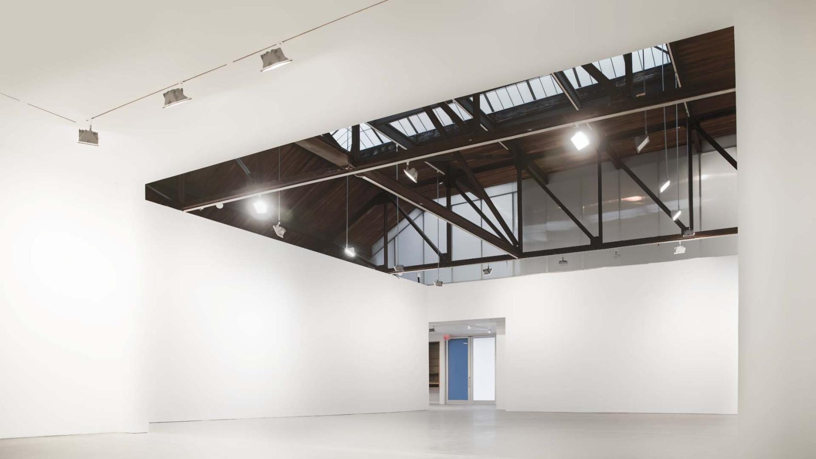 An event venue with high ceilings, skylights, and white gallery-style walls at Studio 525.