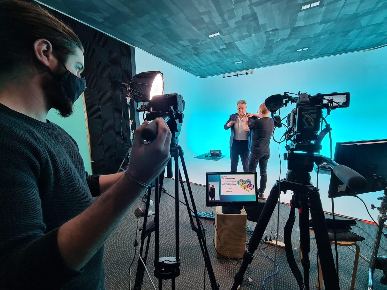 A photo studio with a cyclorama wall, professional lighting, cameras, and soundproof panels at Soundproof Studio.