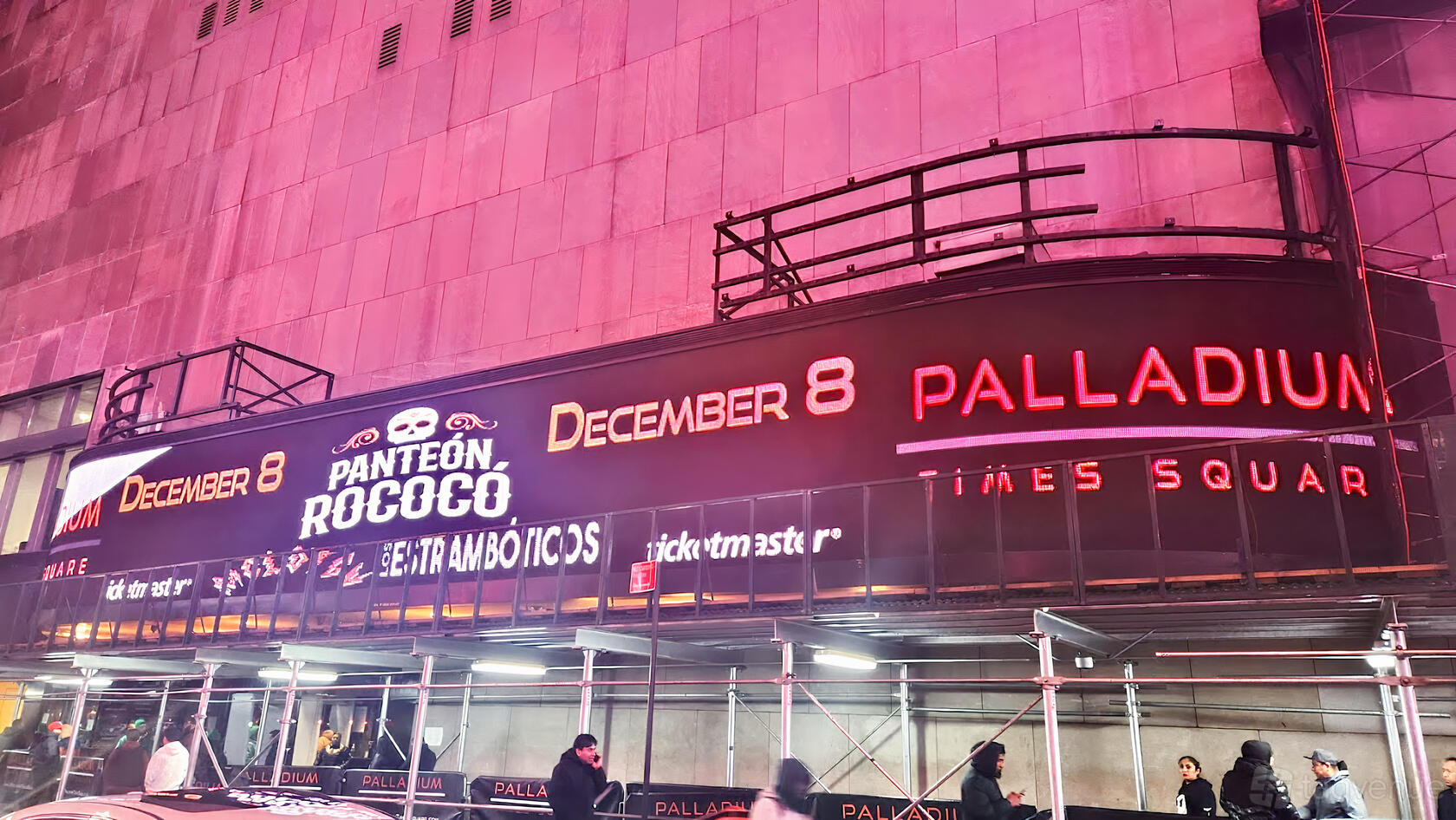 An event venue exterior with large digital marquees displaying event information at Palladium Times Square.