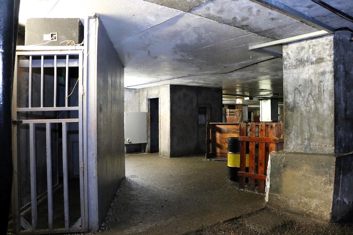 An underground event venue with concrete floors, exposed beams, and industrial walls at Bunker 51.