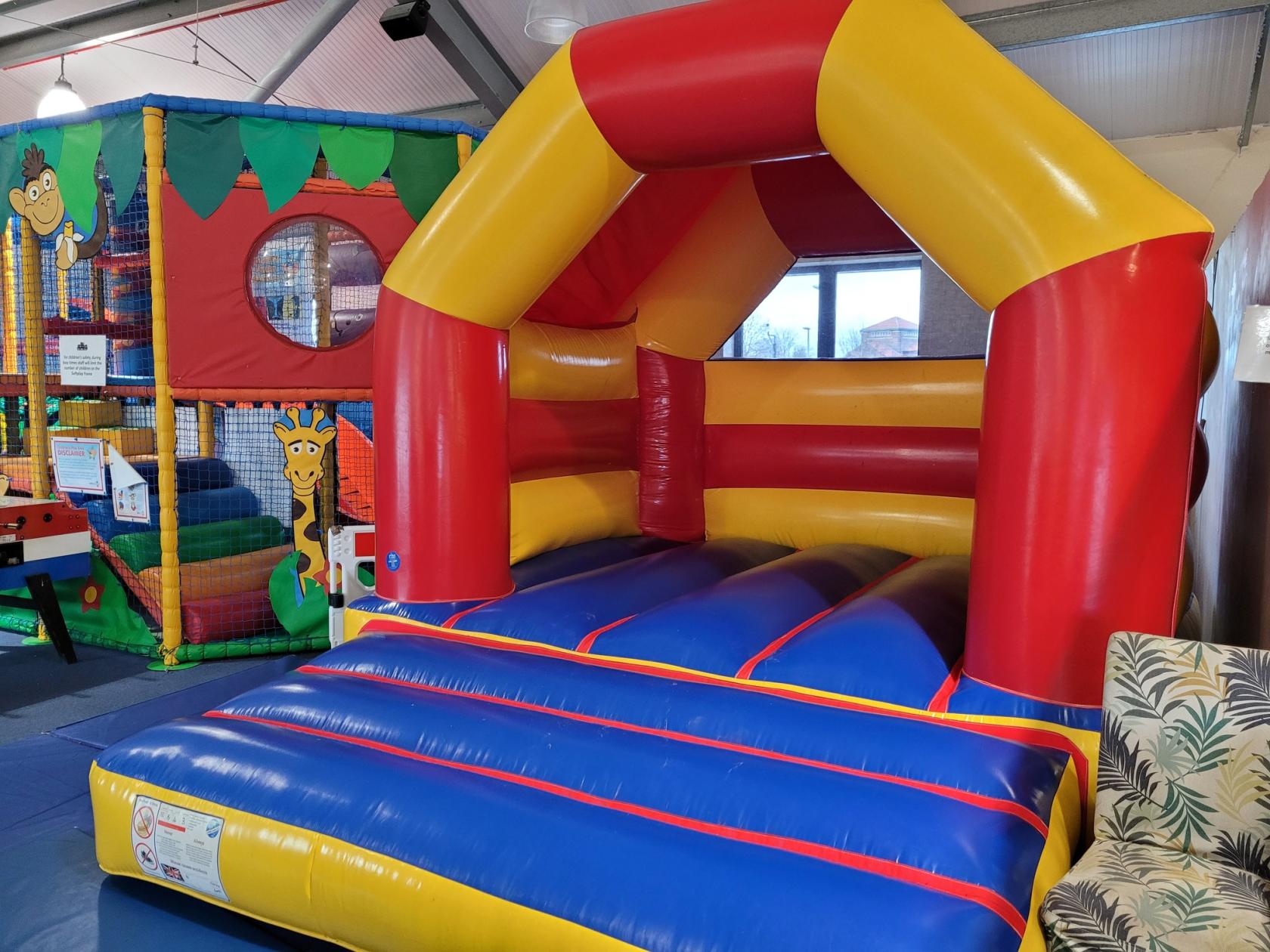 An event venue with a colorful indoor bouncy castle and soft play structure at The Hideaway Manchester.