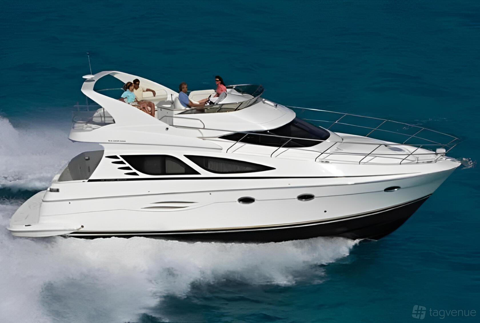 A white yacht cruising over blue water with multiple decks and passengers on the upper level at Lots Of Yachts/Lots Of Spots - New York.