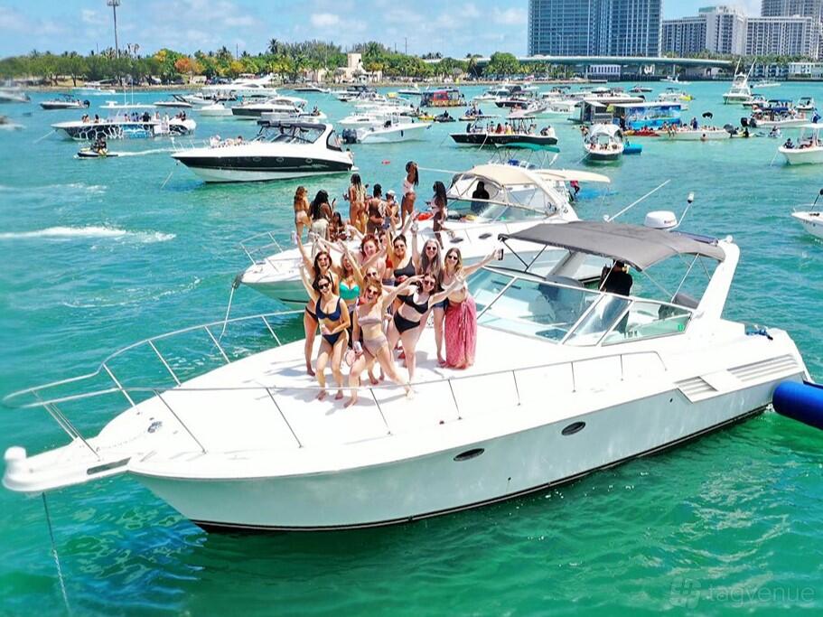 A yacht with an open deck, white exterior, and sunbathing area on the water at Ocean View Yacht Charters.
