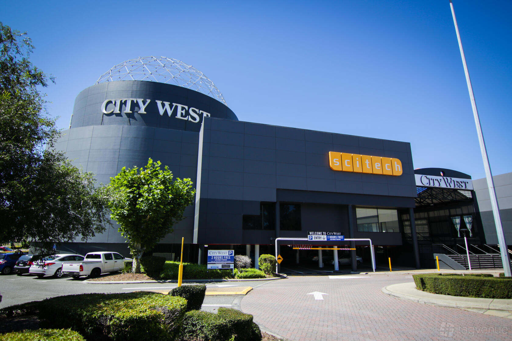 A museum exterior with dark curved walls, a large dome structure, and Scitech signage at Scitech Science Centre.