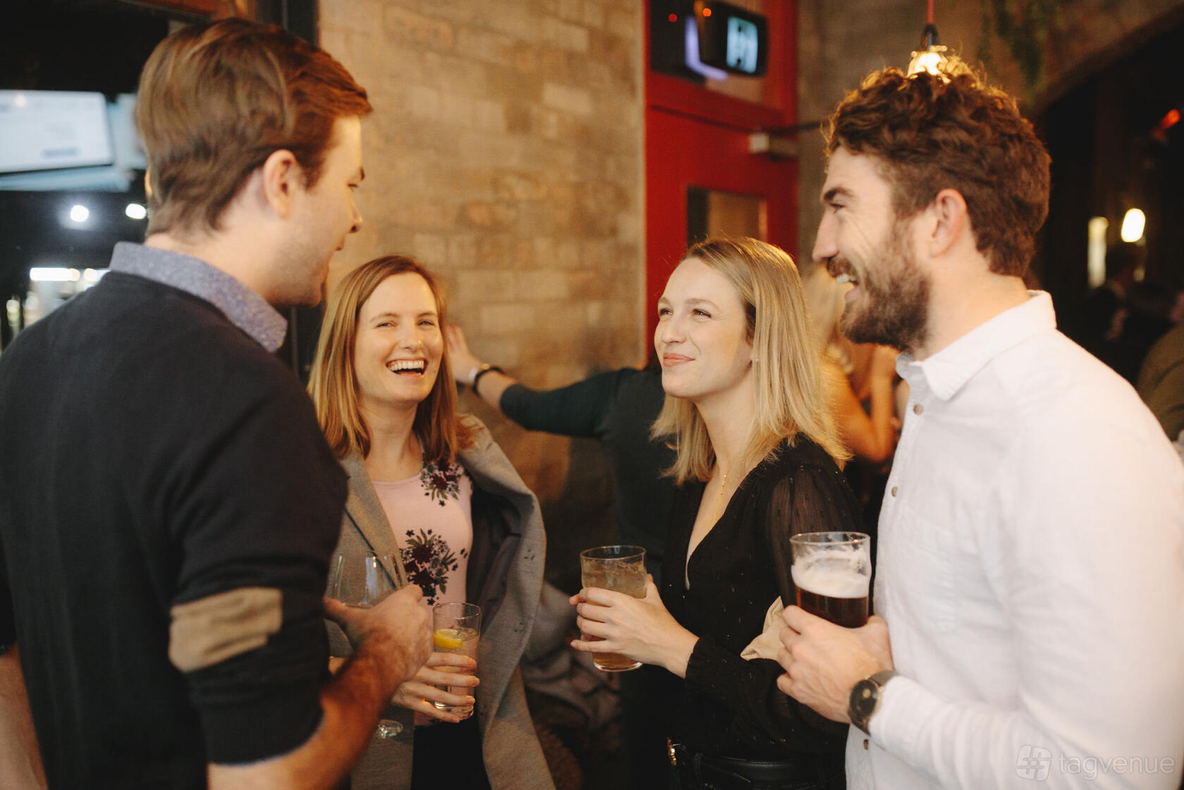 A function room with exposed brick walls and warm pendant lighting at The National Hotel.