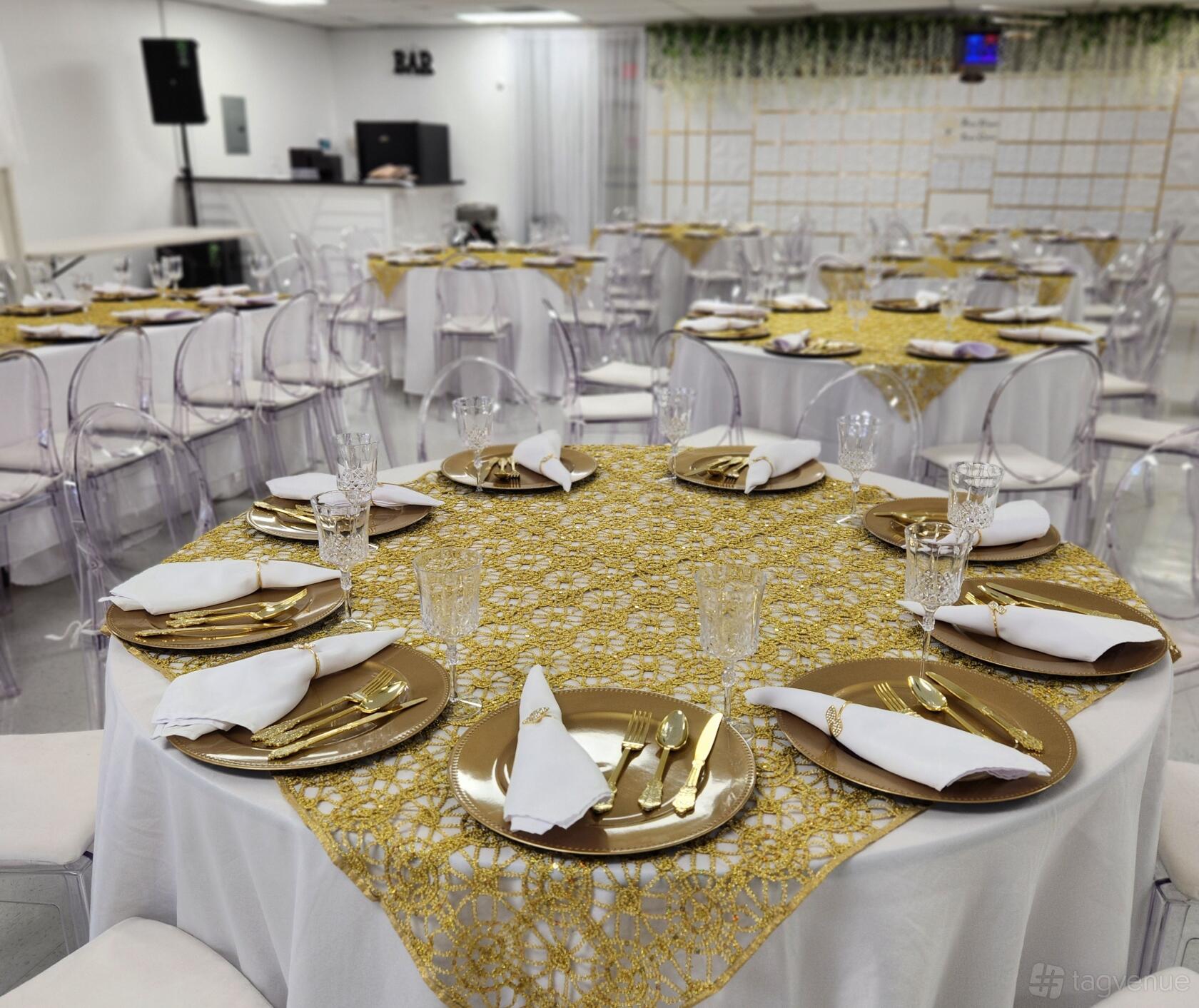 An event venue with round tables covered in gold-patterned linens and clear chairs at Praise Elegant Event Center.