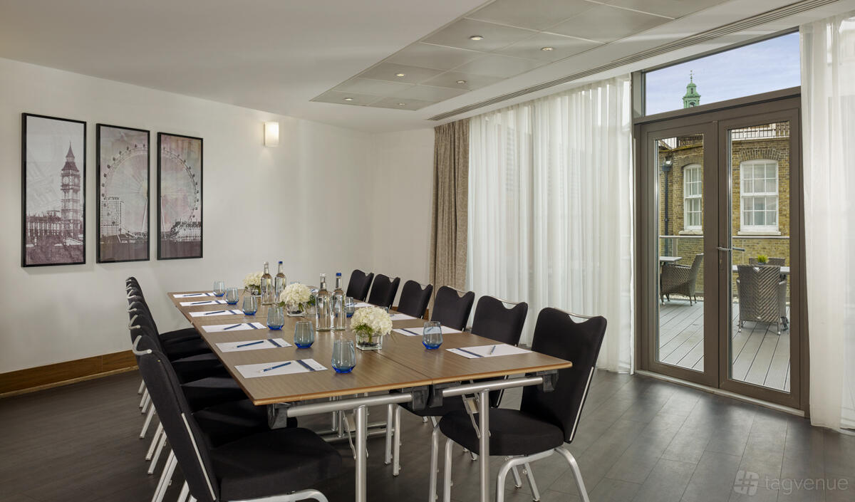 A meeting room with floor-to-ceiling windows, a long boardroom table, and access to a private terrace at Park Plaza County Hall London.