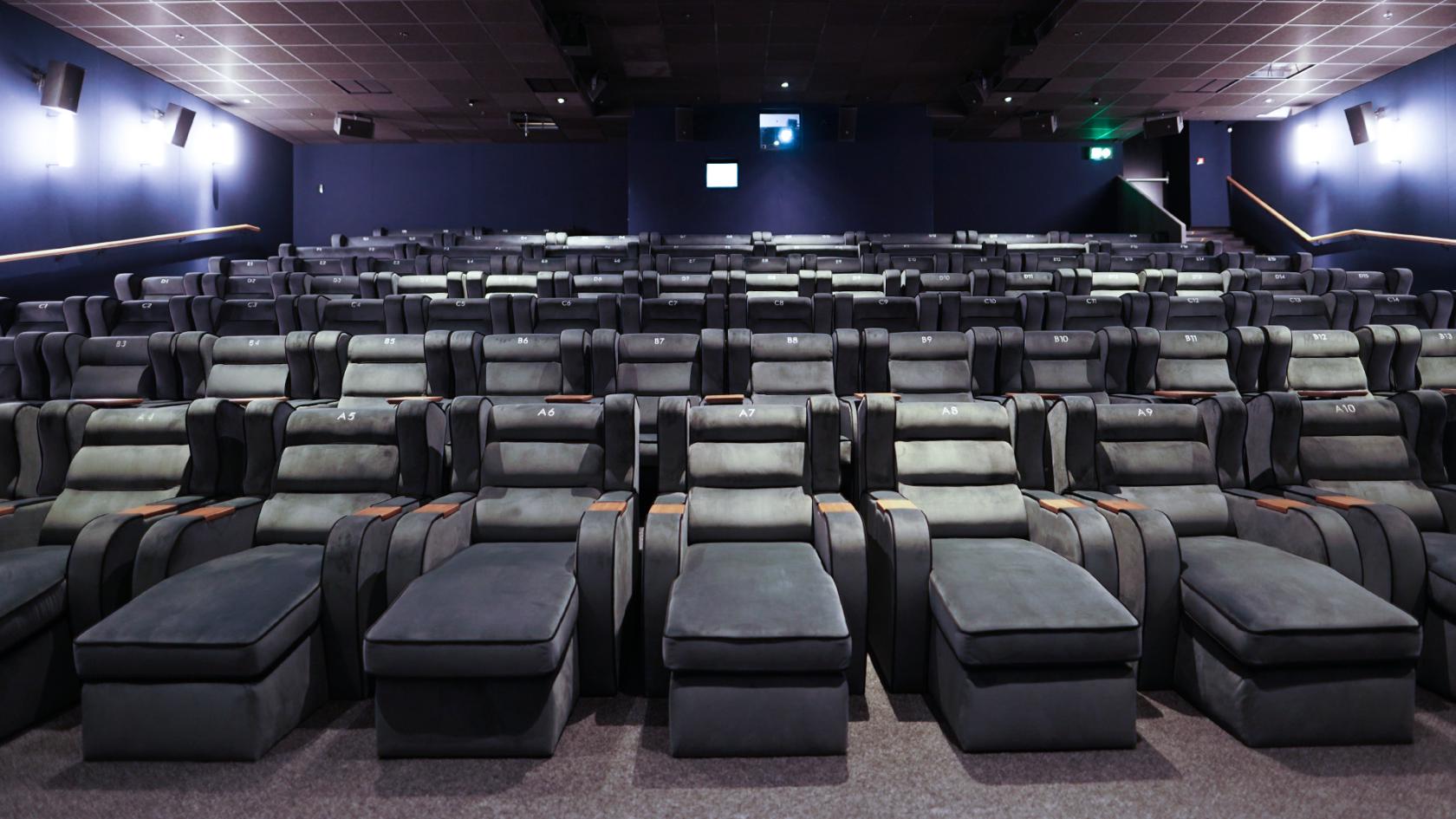 A cinema screening room with plush reclining seats and footrests at Curzon Kingston