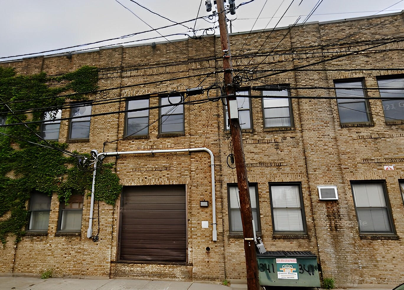 A versatile event space with exposed brick exterior and large warehouse-style windows at Activated Studios.