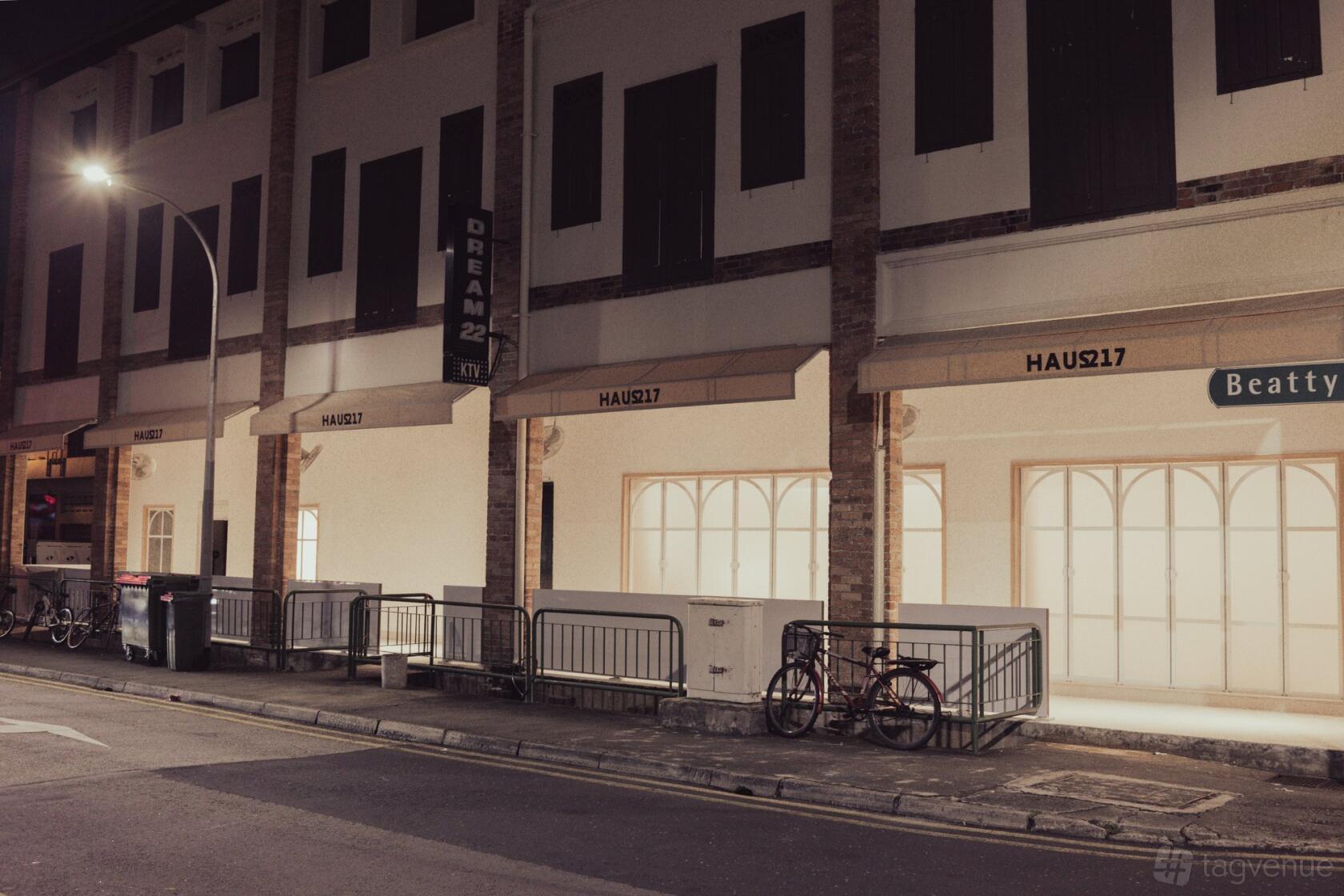 A versatile event space with large arched windows and illuminated façade at HAUS217.