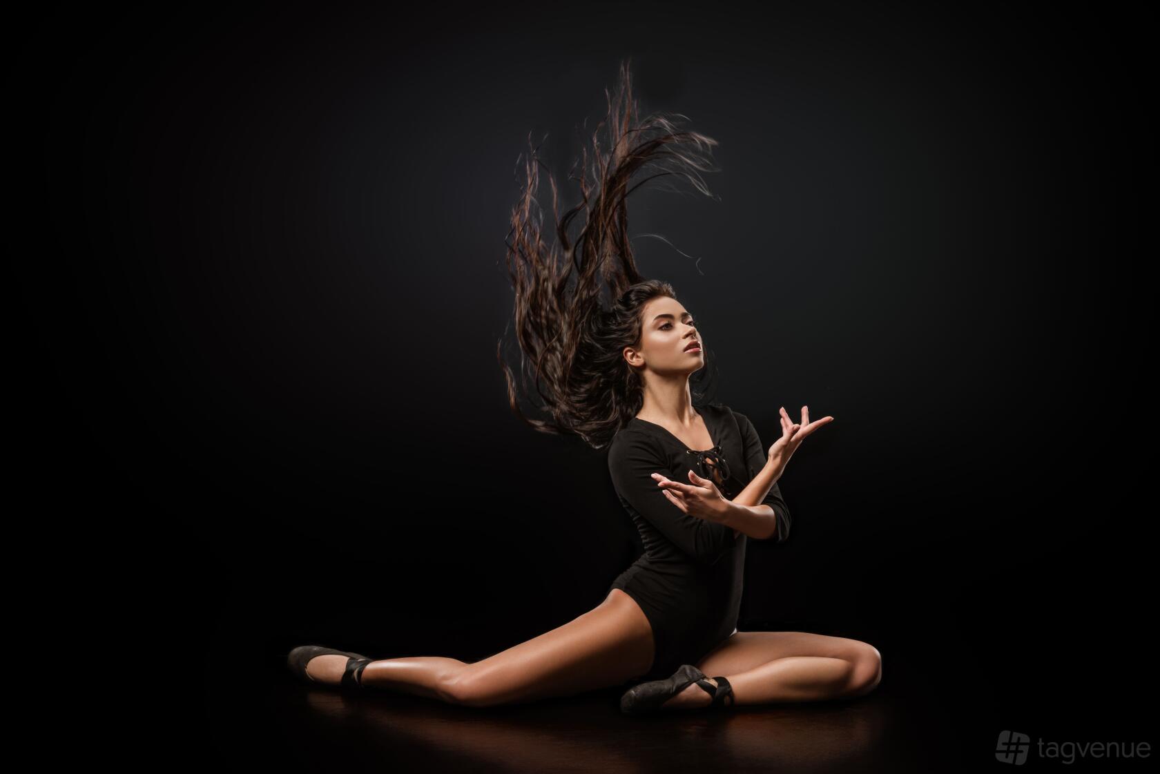 A photo studio with a dark backdrop and glossy floor at Finchley Studio London