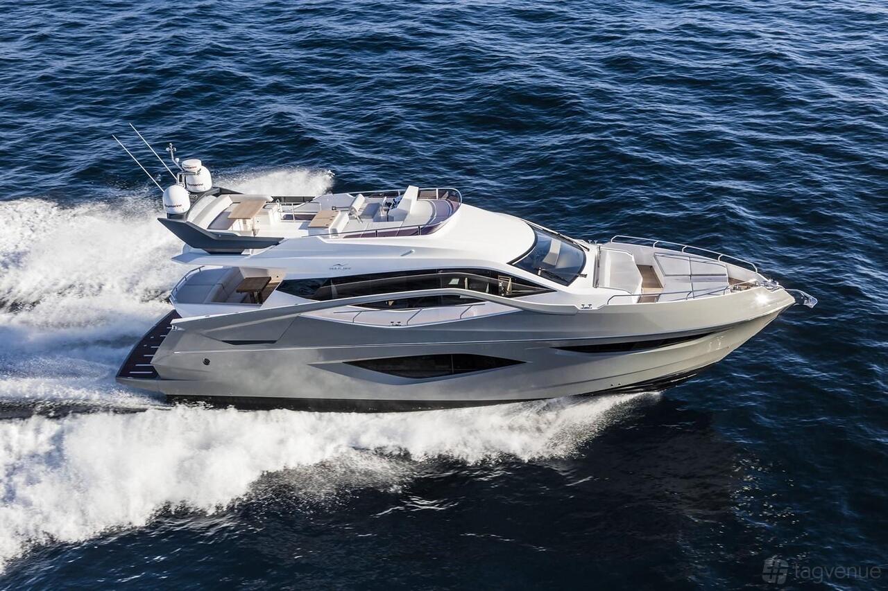 A luxury boat with sun decks and sleek design cruising on open water at Terrific Boat Charters.