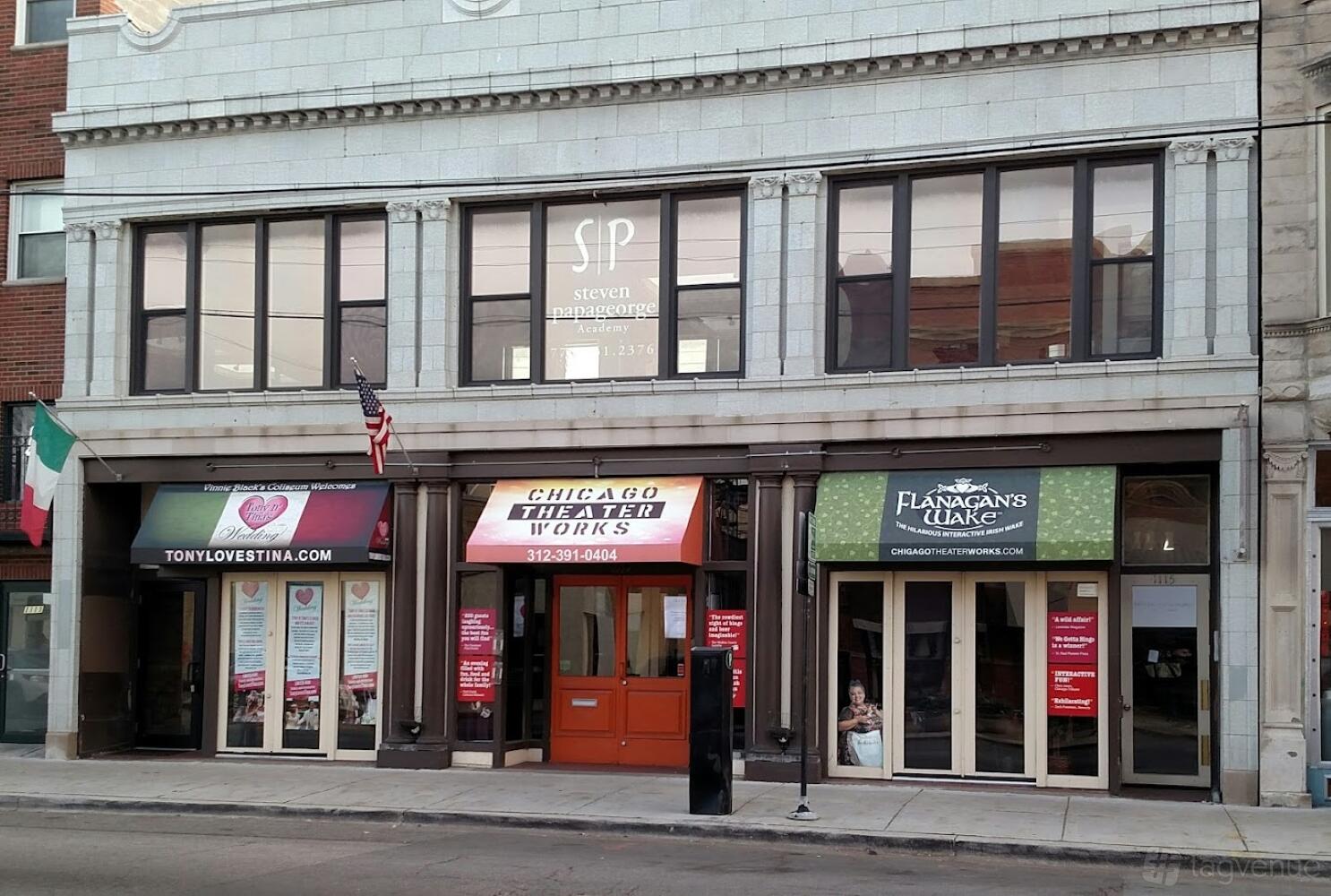 A versatile event space with a classic stone facade and large windows at Chicago Theater Works.