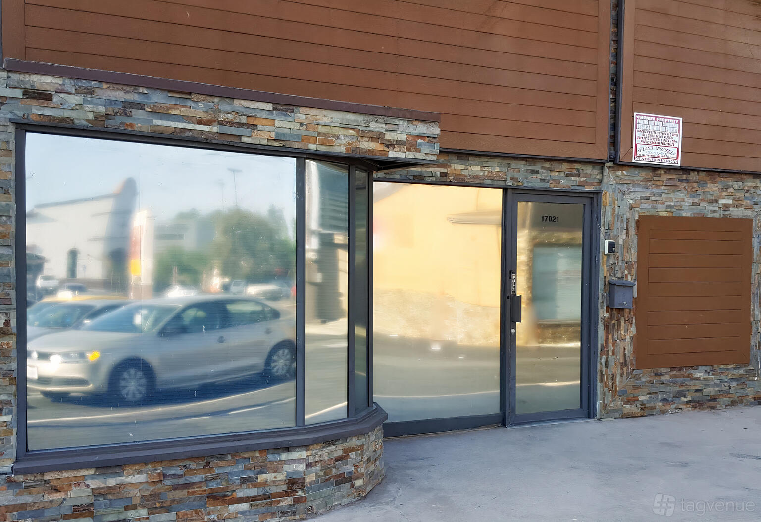 A recording studio exterior with large reflective windows and stone accents at Big City Recording Studios.