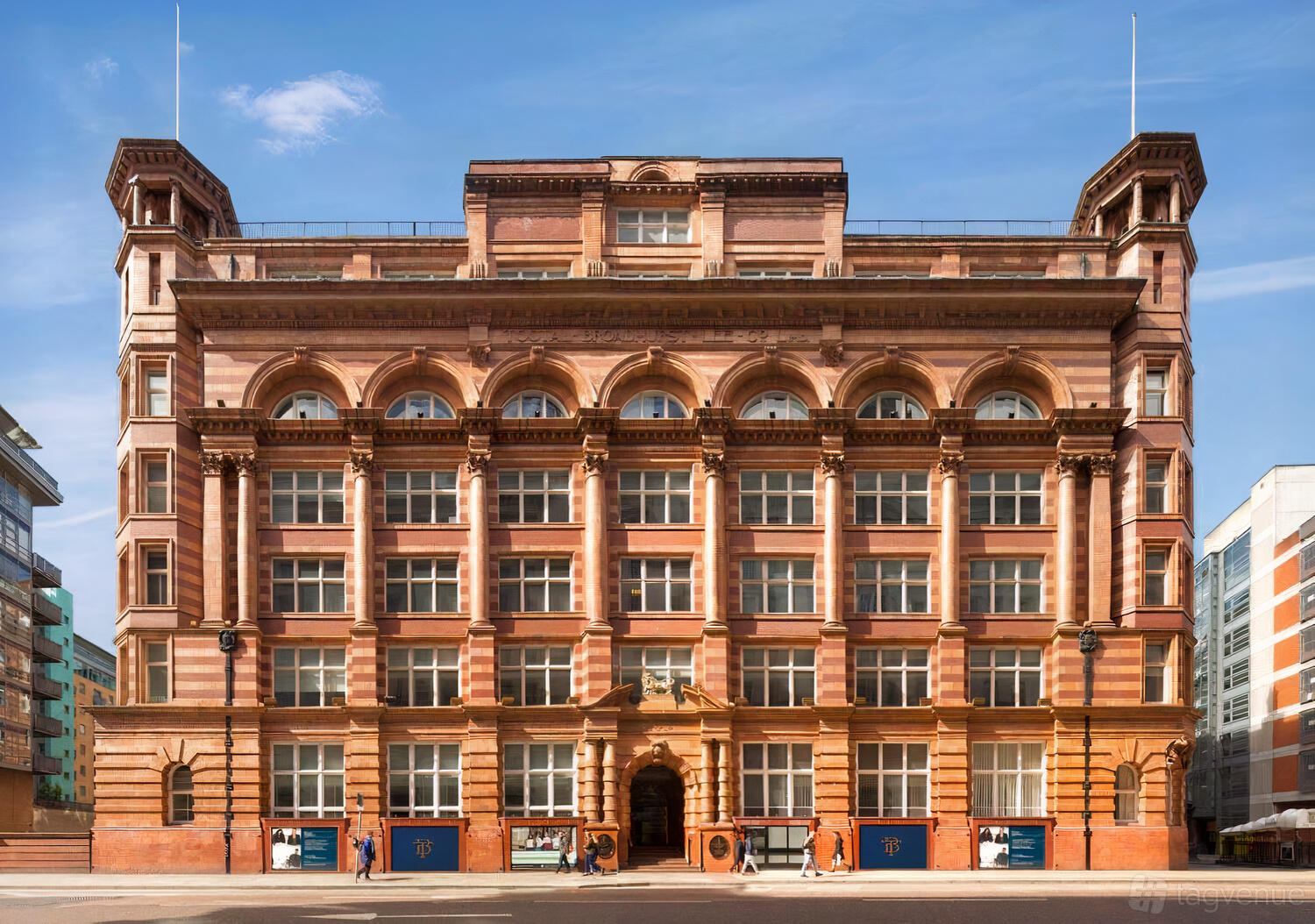 A historic meeting centre with red brick façade, large arched windows, and ornate detailing at Orega The Tootal Buildings.