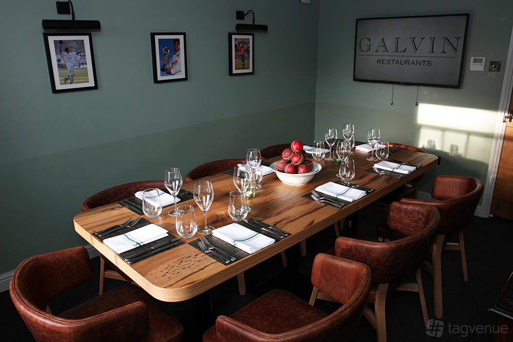 A dining room with a wooden table set for eight, leather chairs, and cricket-themed decor at Galvin Green Man.