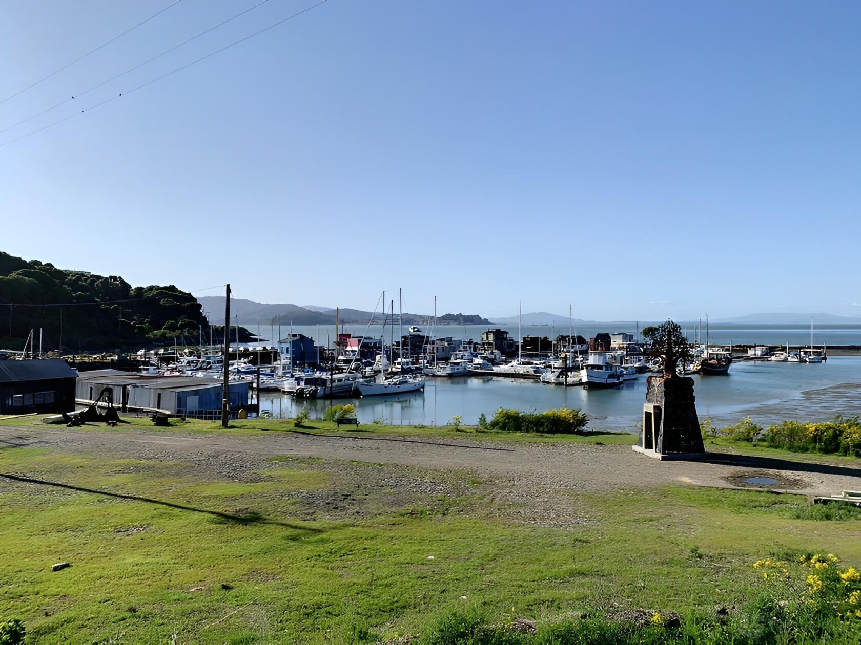 A waterfront event venue with a marina, docked boats, and grassy open space at Point San Pablo Harbor.