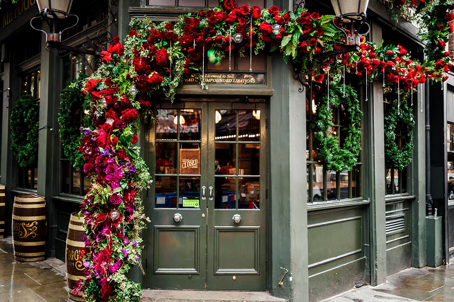 A pub with green paneled doors, floral garlands, and barrel decor at Mr Fogg's Tavern.