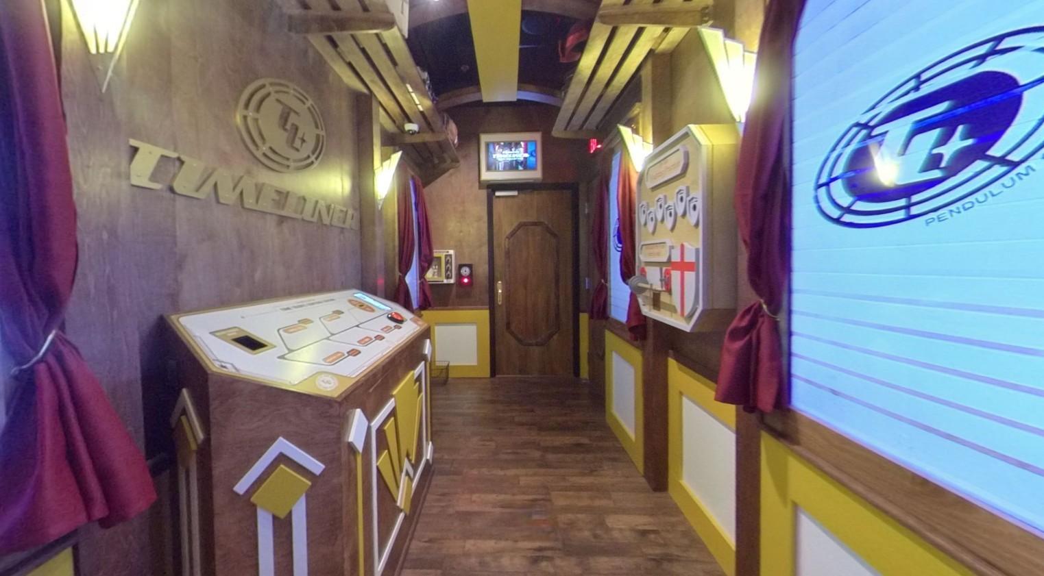 An event venue with wood-paneled walls, interactive puzzle stations, and train-themed decor at The Escape Game Houston- City Center.