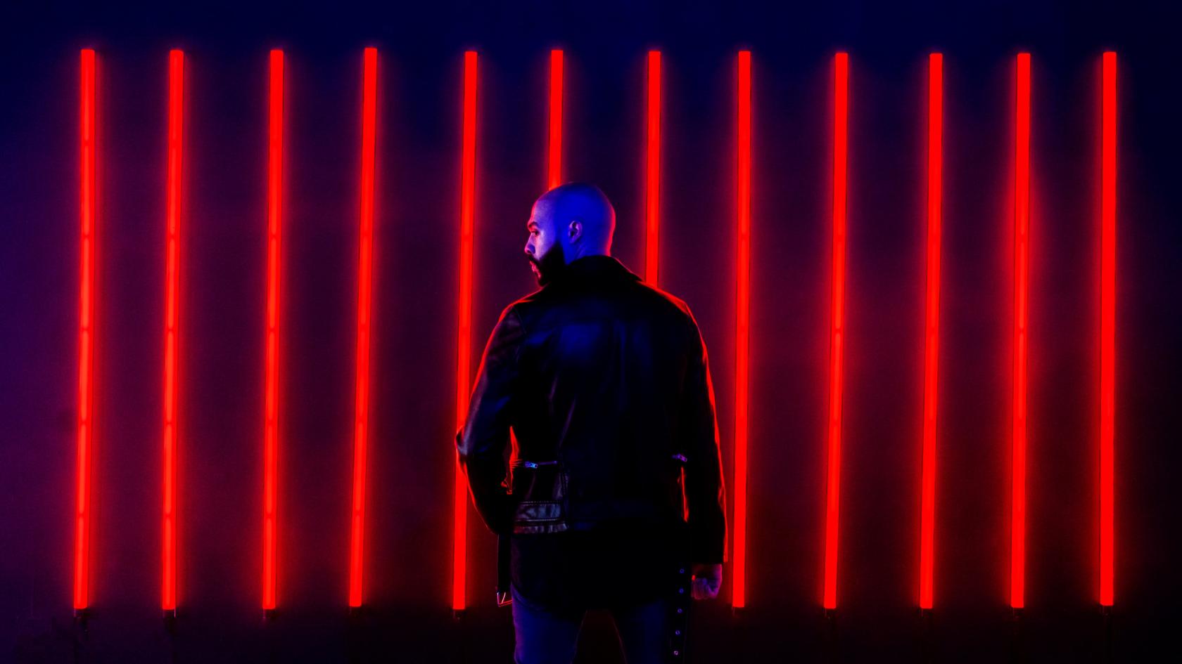 A photo studio with vertical red LED light tubes on a dark wall at The Boombox Room Johnson Avenue.
