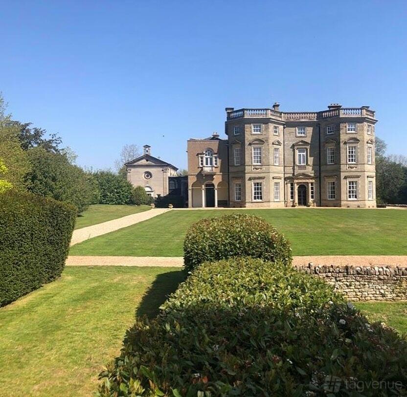A historic hall with grand stone architecture and manicured lawns at Bourton Hall.
