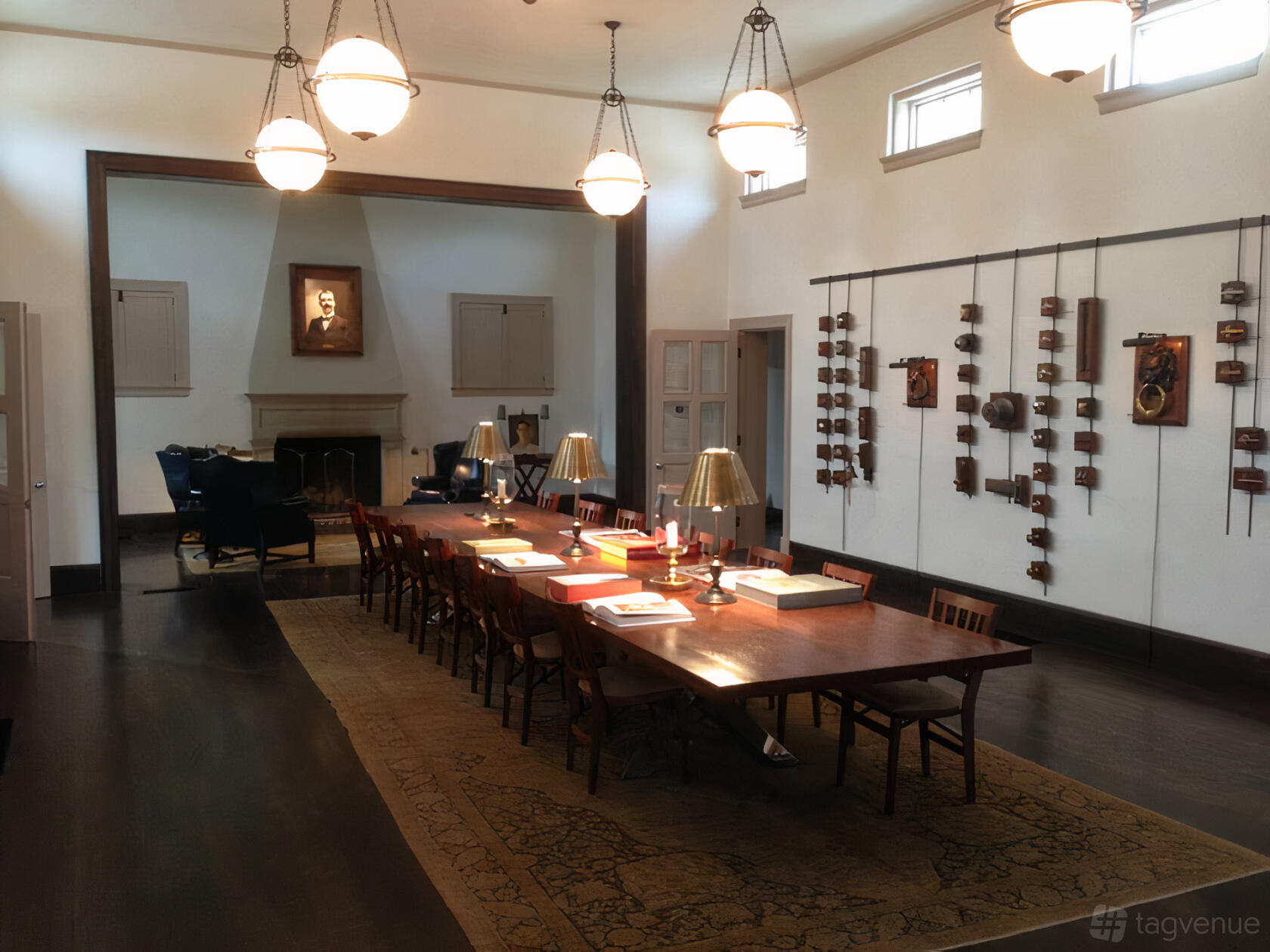 A library event space with a long wooden table, reading lamps, and bookshelves at Roosevelt Library.