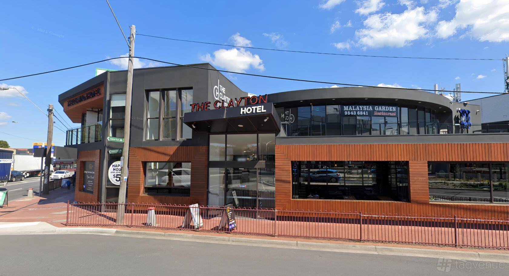 A versatile event space with a modern glass façade and wood panel accents at The Clayton Hotel.
