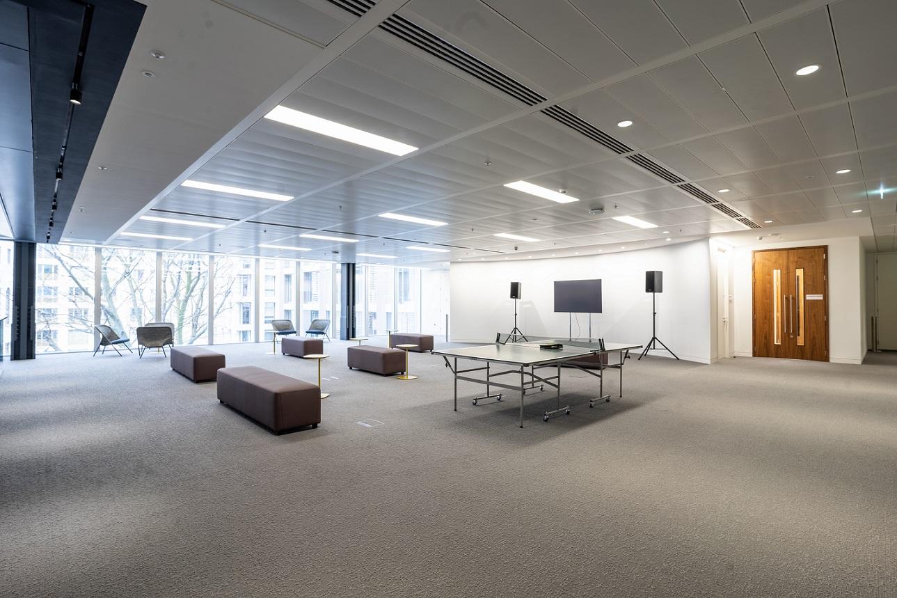 An event space with floor-to-ceiling windows, modular seating, and a ping pong table at London Conference Centre.