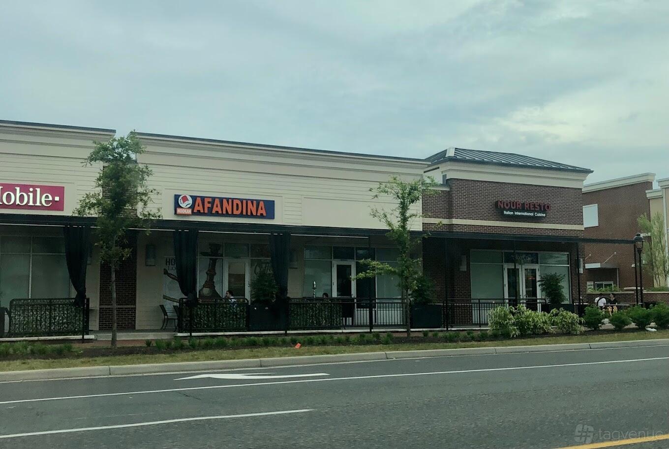 A bar with a sidewalk patio, glass storefront, and AFANDINA HOOKAH LOUNGE signage above the entrance.