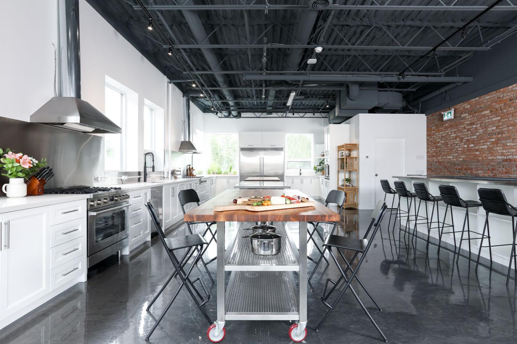 Kitchen Studio at Rily Kitchen at its center is a handcrafted grand table that is ideal for meetings